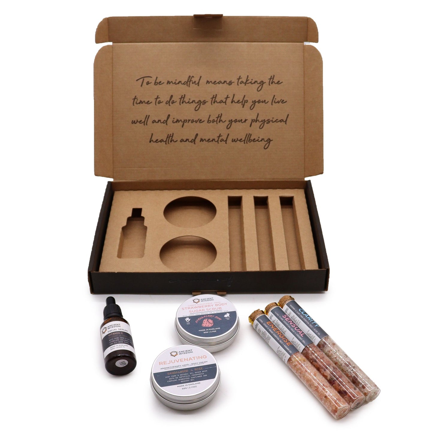 Self-care gift set in an open kraft box with body scrub, bath salts, oil and balm
