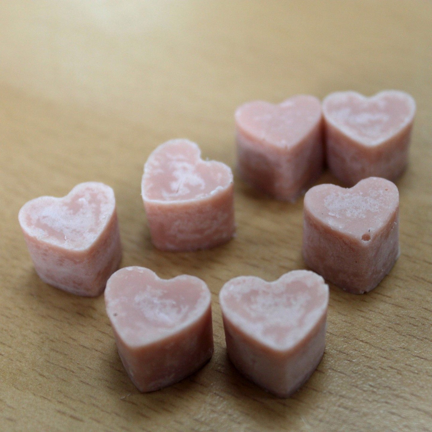 Ginger and clove aroma wax melts in glass jar with soy wax hearts