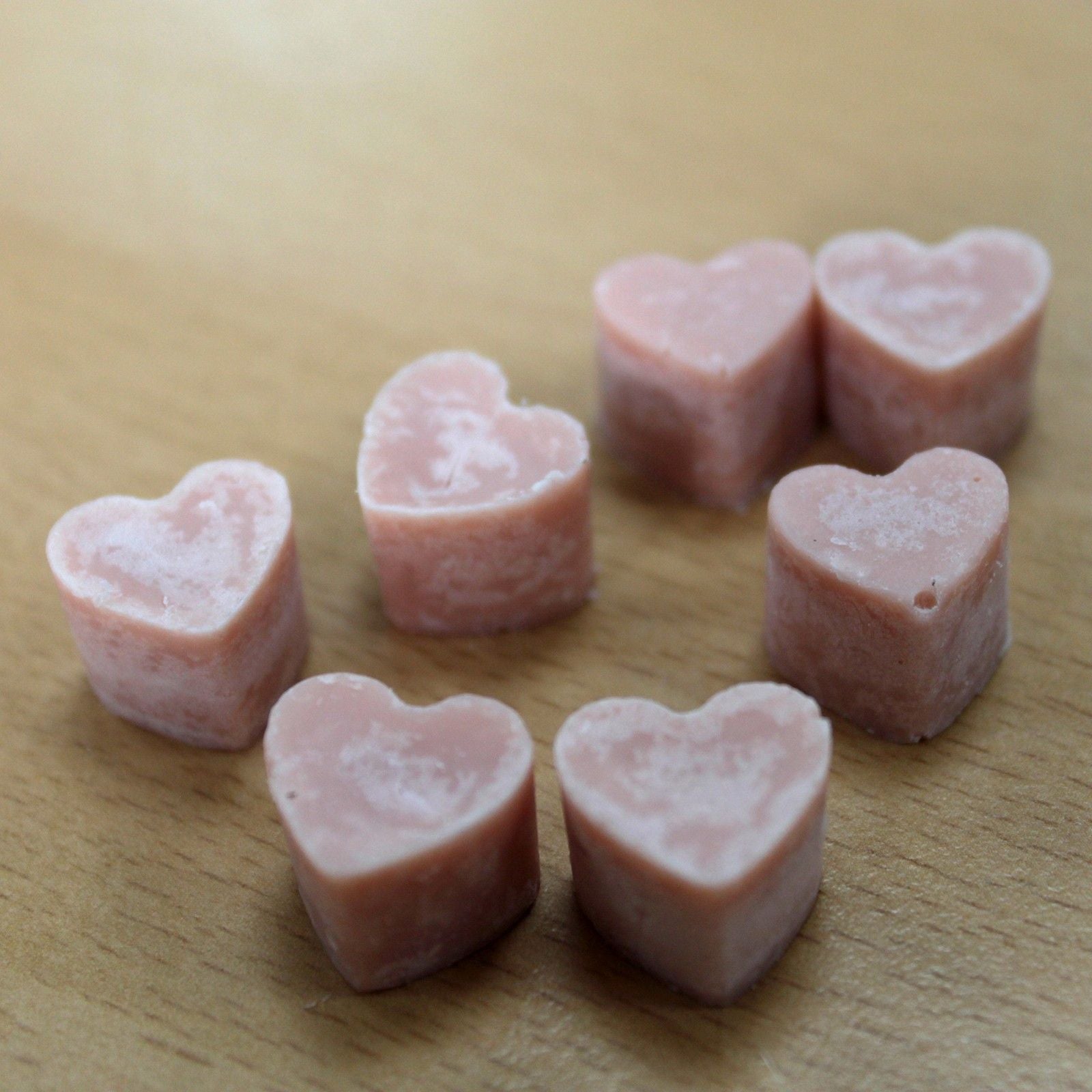 Ginger and clove aroma wax melts in glass jar with soy wax hearts