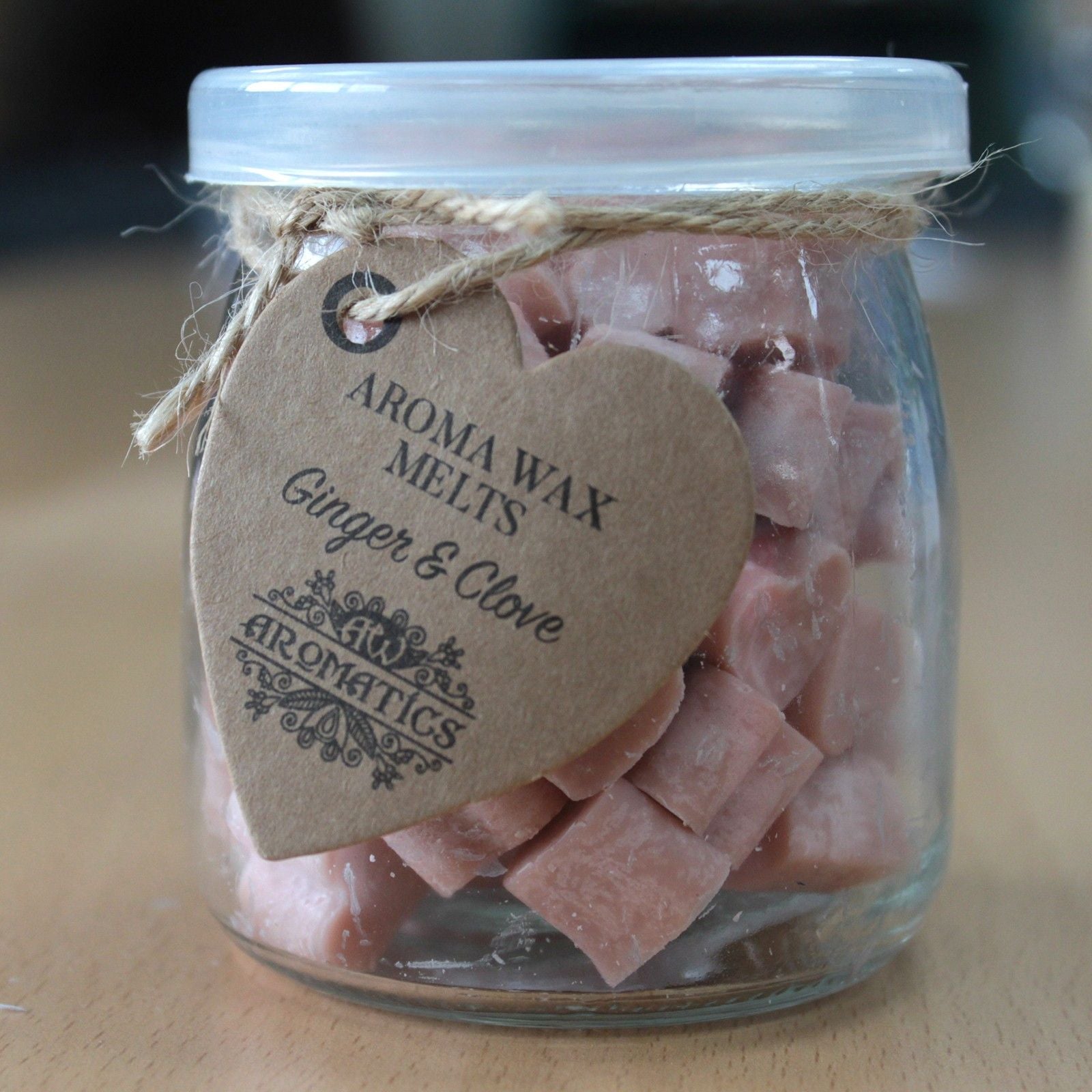 Ginger and clove aroma wax melts in glass jar with soy wax hearts