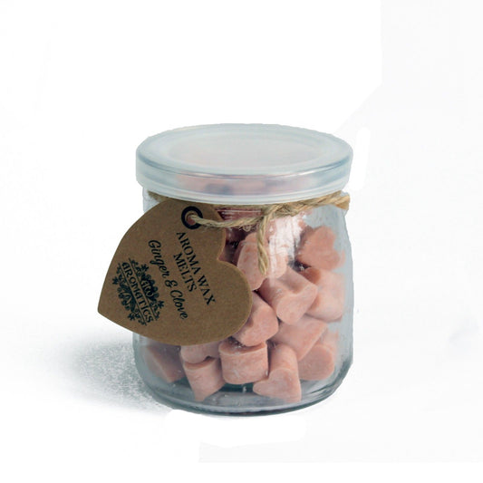 Ginger and clove aroma wax melts in glass jar with soy wax hearts