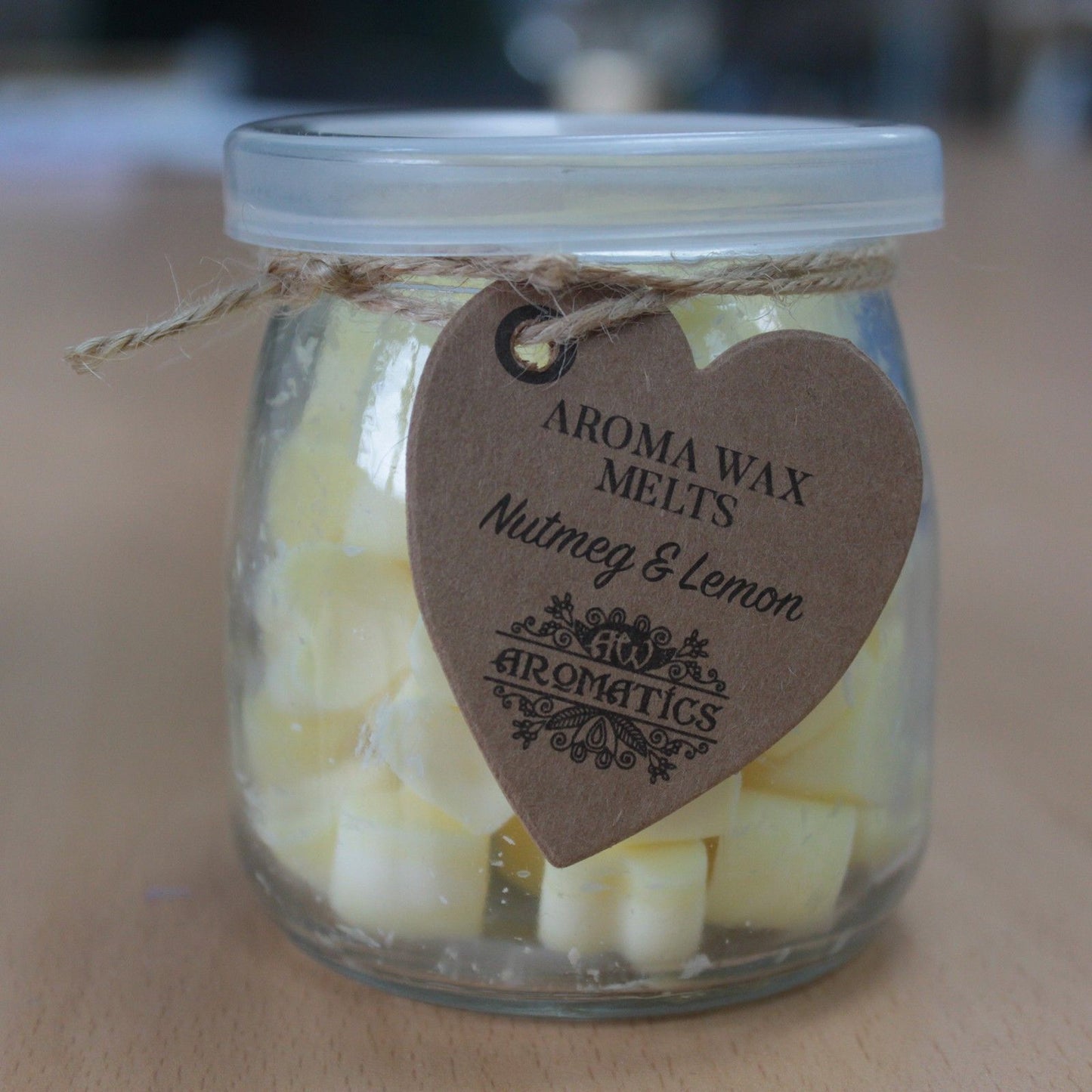 Nutmeg and lemon aroma wax melts in glass jar with soy wax hearts