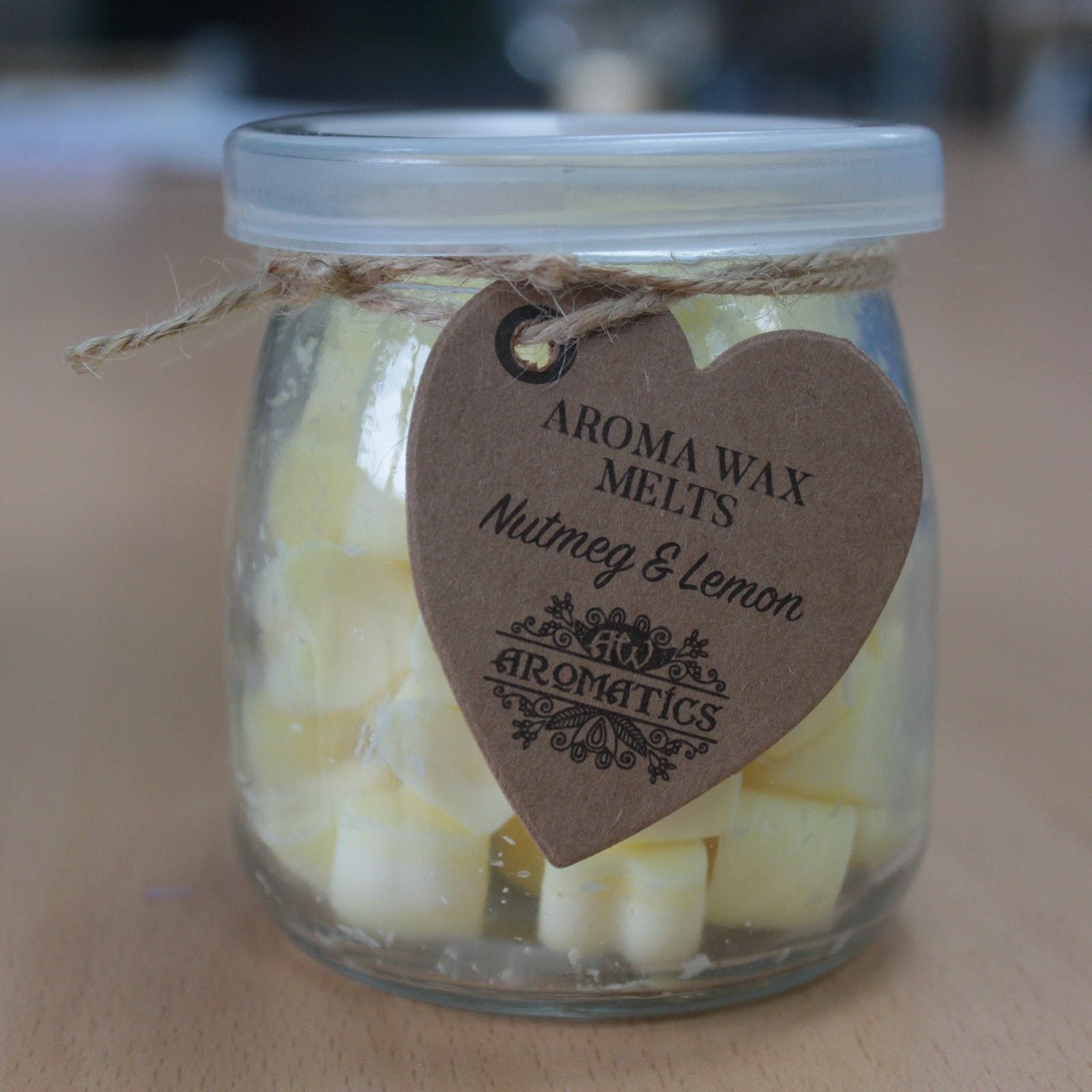 Nutmeg and lemon aroma wax melts in glass jar with soy wax hearts