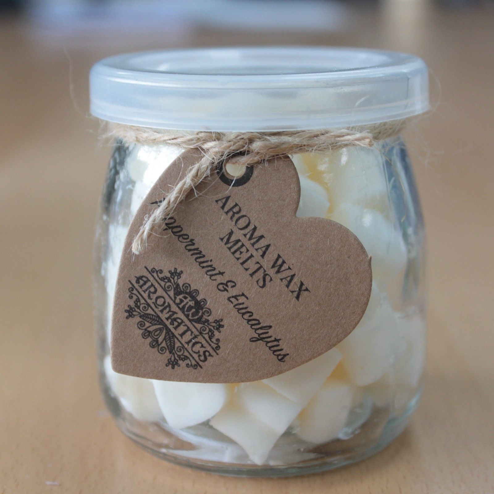 Ylang ylang and orange aroma wax melts in glass jar with soy wax hearts