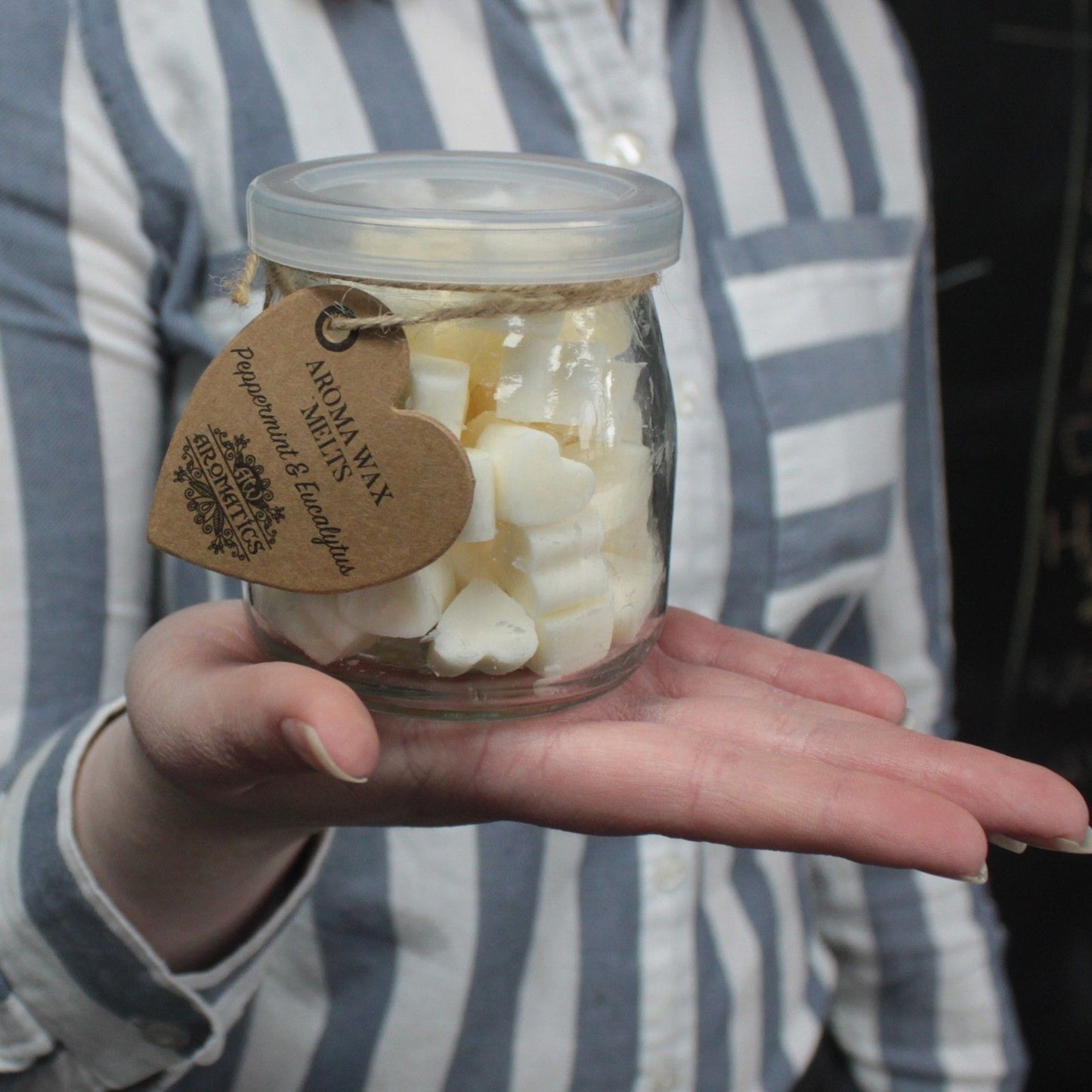 Ylang ylang and orange aroma wax melts in glass jar with soy wax hearts