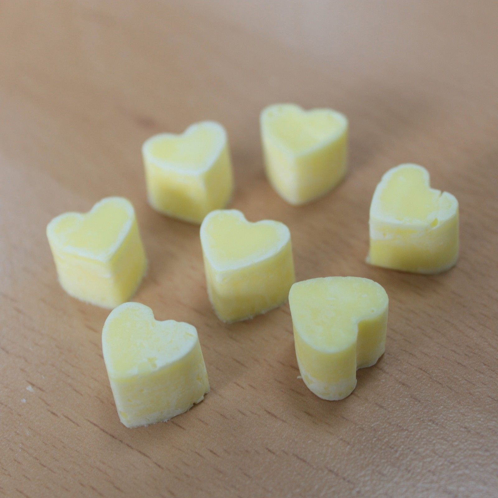 Ylang ylang and orange aroma wax melts in glass jar with soy wax hearts