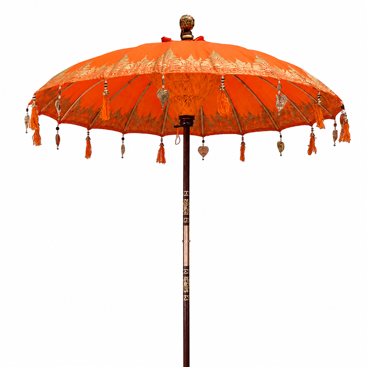 Orange Bali patio parasol with decorative gold detailing, tassels and wooden pole in outdoor setting