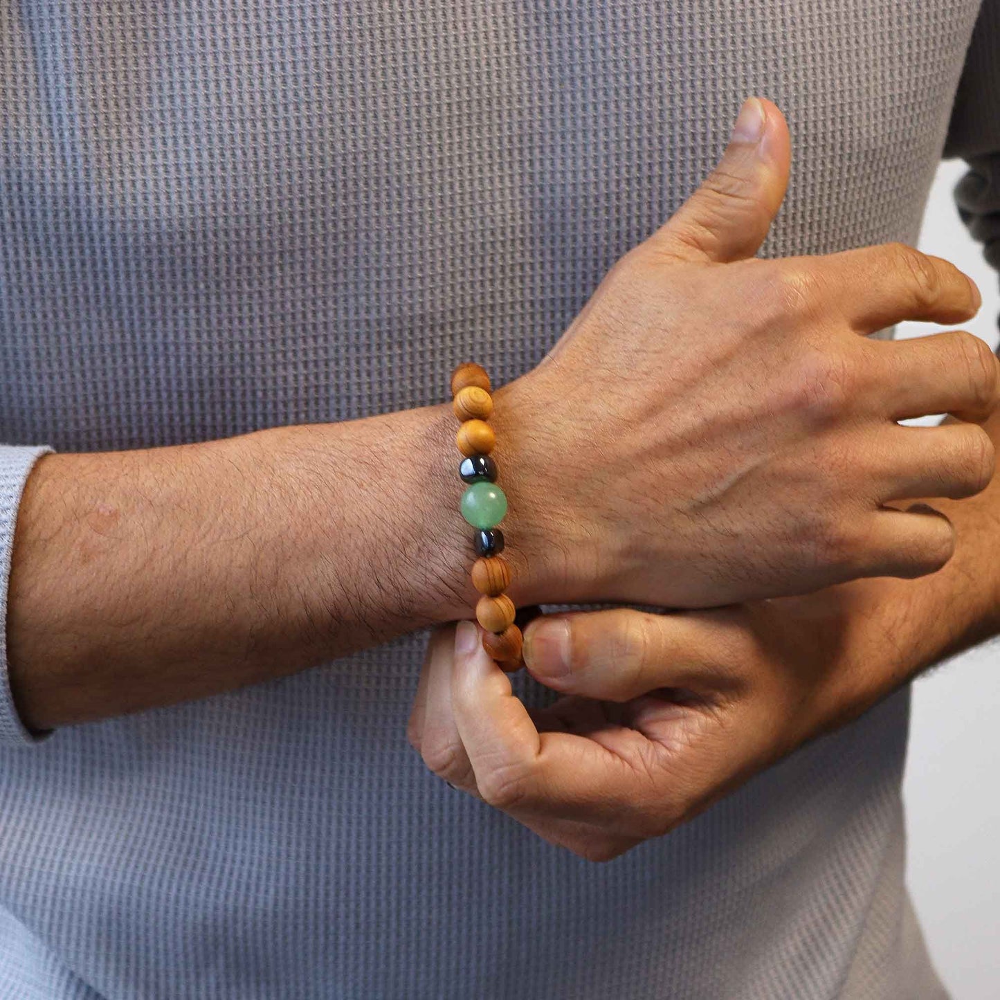 Cedarwood bead bracelet with green aventurin gemstone and dark accent beads for Sacral Chakra design