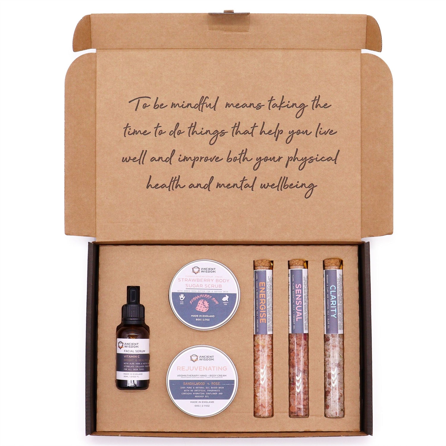 Self-care gift set in an open kraft box with body scrub, bath salts, oil and balm