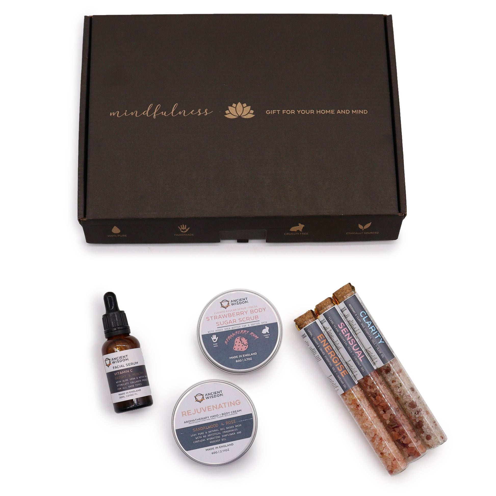 Self-care gift set in an open kraft box with body scrub, bath salts, oil and balm