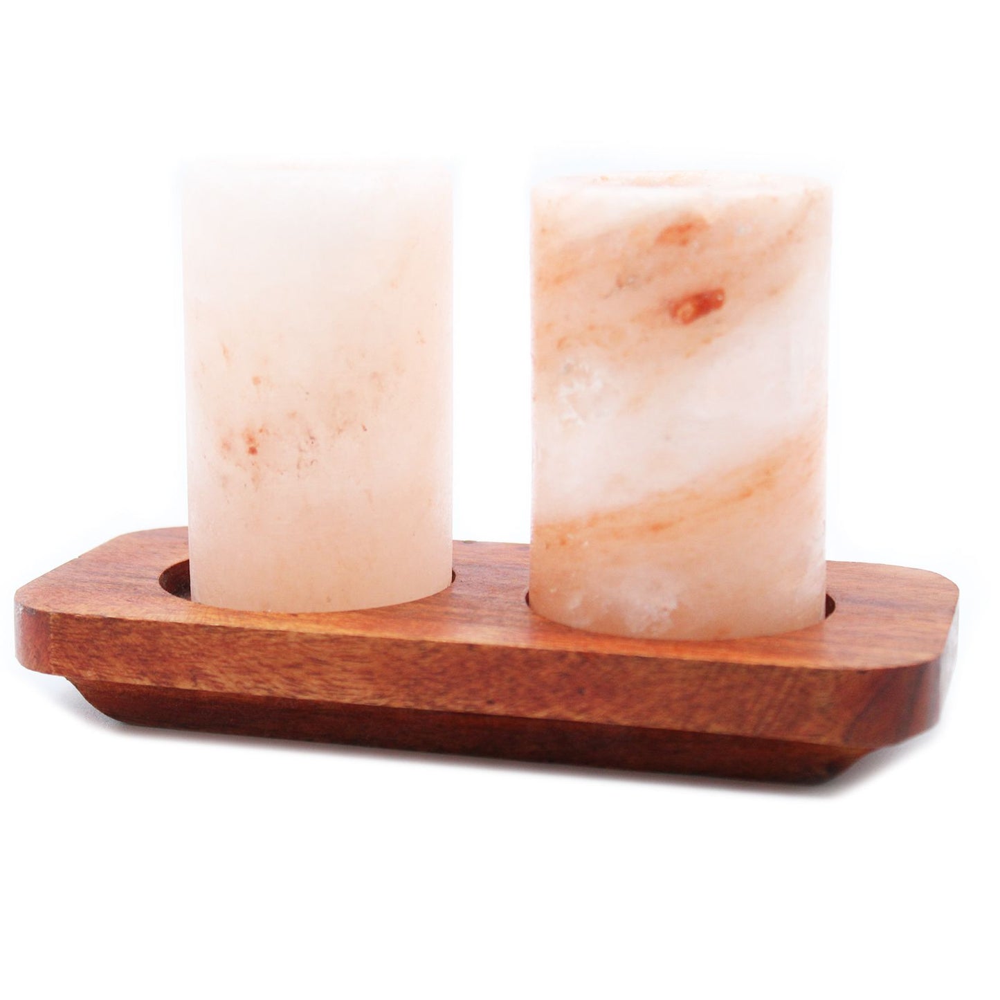 Two Himalayan salt shot glasses on a wooden serving stand with gift box
