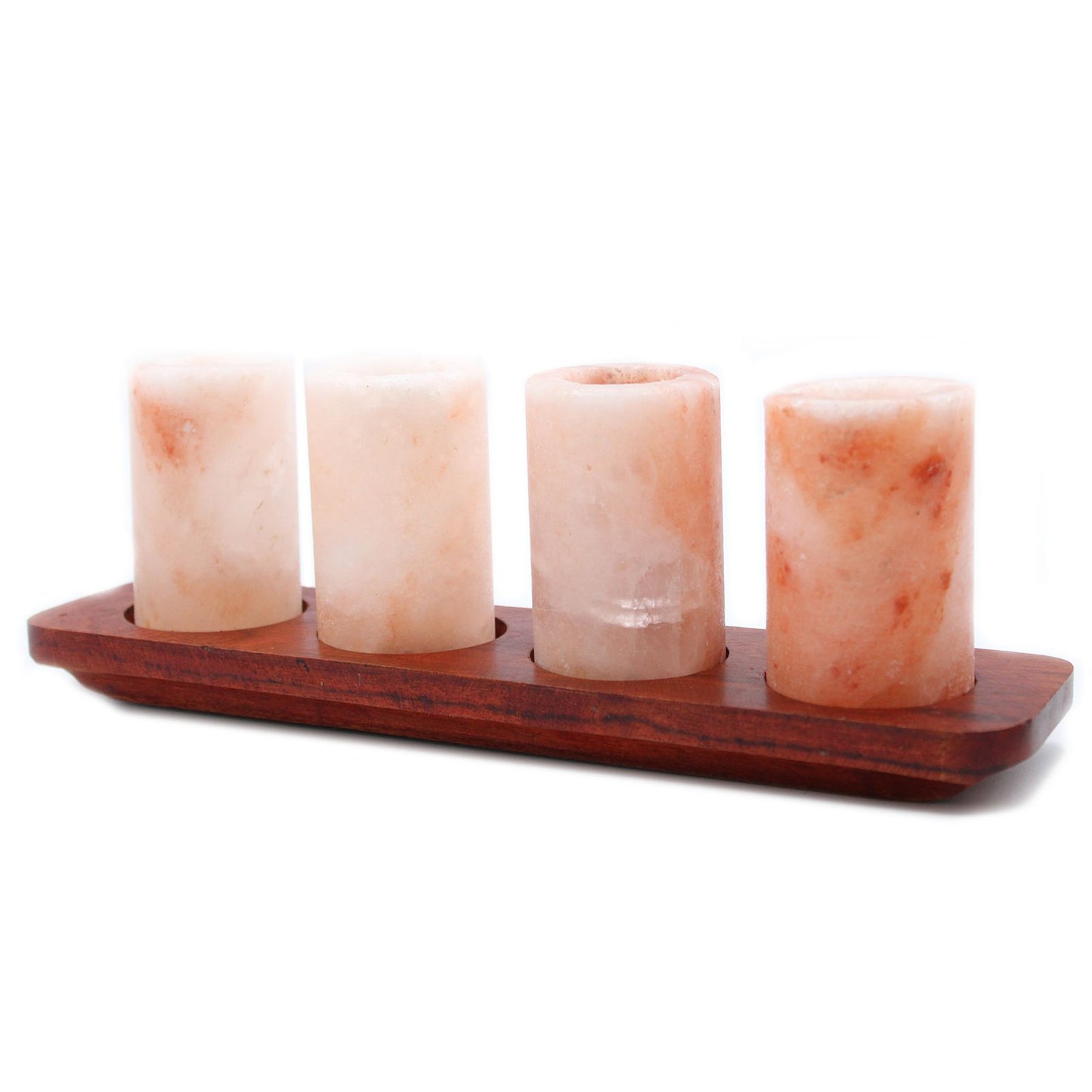 Four Himalayan salt shot glasses on a wooden serving stand with gift box